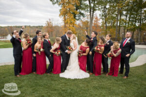 It's time for the wedding grooms and bridesmaids to gather and capture a beautiful photo The grooms and bridesmaids come together for a lovely photo at the wedding.