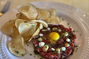 Indulge in freshly prepared potato chips paired with a cranberry sauce